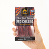 Hand holding a package of Thai Bird Pepper Red Chillies with Siam branding.