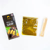 Siam Satay BBQ Kit with marinade packet and bamboo skewers on a white background