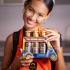 Woman holding a pack of Tuk Tuk gift set Siam Thai Dipping Sauces in a kitchen setting